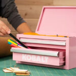 A Person Using a Kobalt Mini 2 Drawer Pink Steel Tool Box to Organize his Pens