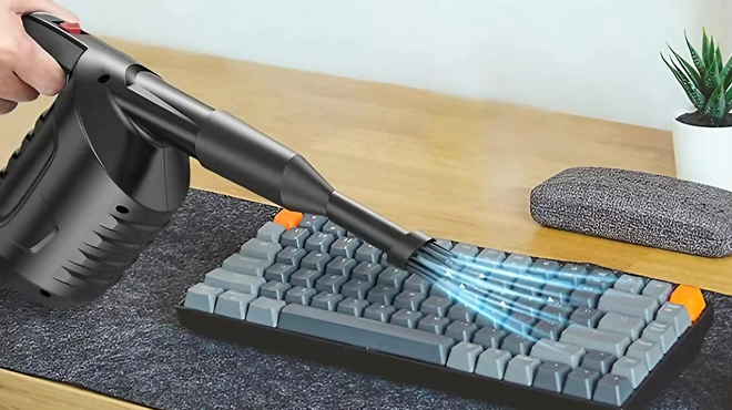 A Person Using an Electric Compressed Air Duster Blower