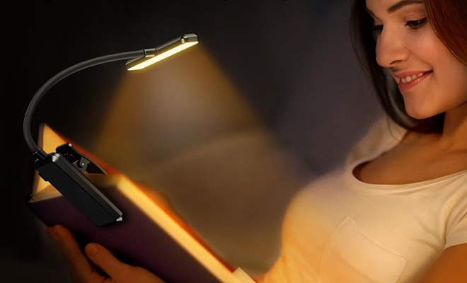 A Person Using the Gritin 19 LED Rechargeable Book Light for Reading in Bed