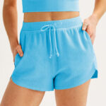 A Person Wearing Juniors SO Waffle Knit Dolphin Hem Shorts in Carolina Blue Color
