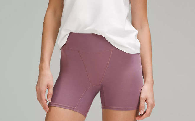 A Person Wearing Lululemon UnderEase Super High Rise Shortie Underwear in Cyber Violet Color