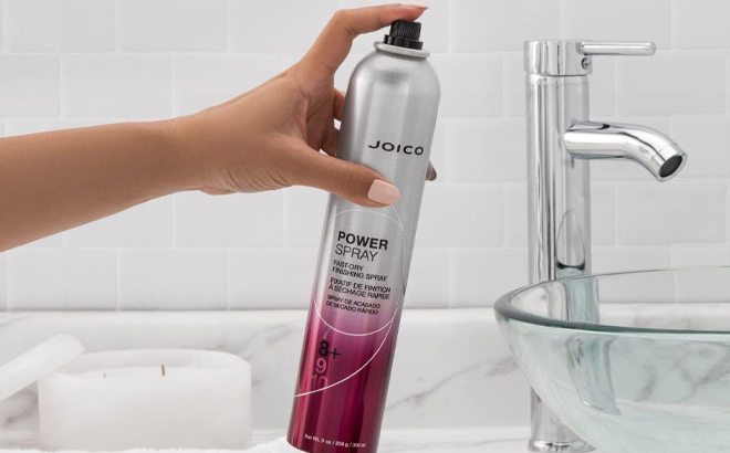A Woman Holding Joico Power Spray Fast Dry Finishing Spray