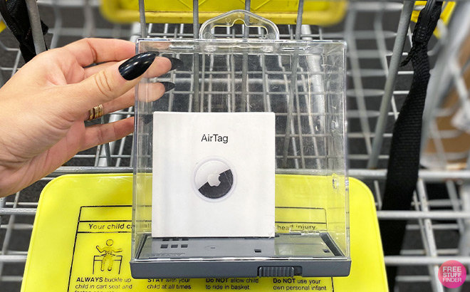 A Woman Holding a Transparent Box with Apple AirTag in it