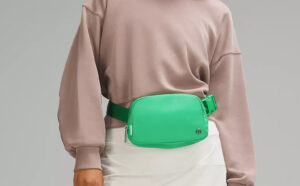 A Woman Wearing Lululemon Everywhere Belt Bag in Green Punch