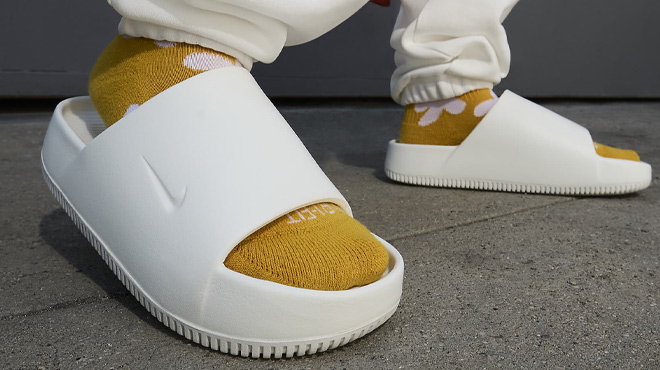 A Woman Wearing Nike Calm Slide Sandal A Woman Wearing Nike Calm Slide Sandal