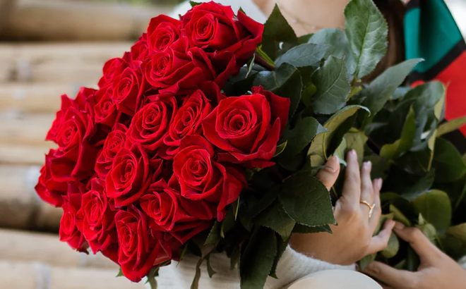 A lady holding Rose Farmers Bouquet