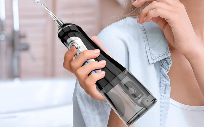 A lady holding a Cordless Water Dental Flosser