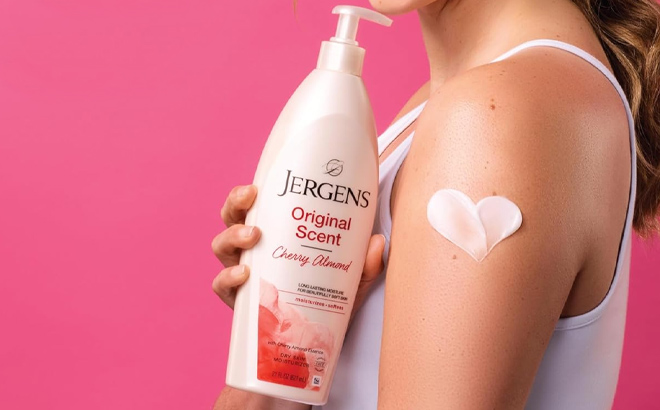 A lady holding a Jergens Original Scent Dry Skin Body Lotion A lady holding a Jergens Original Scent Dry Skin Body Lotion