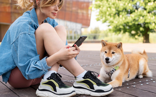 A Woman and Her Shiba Inu Dog Resting on a Wooden Platform