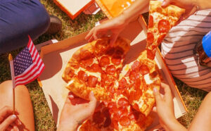 People Holding Pizza
