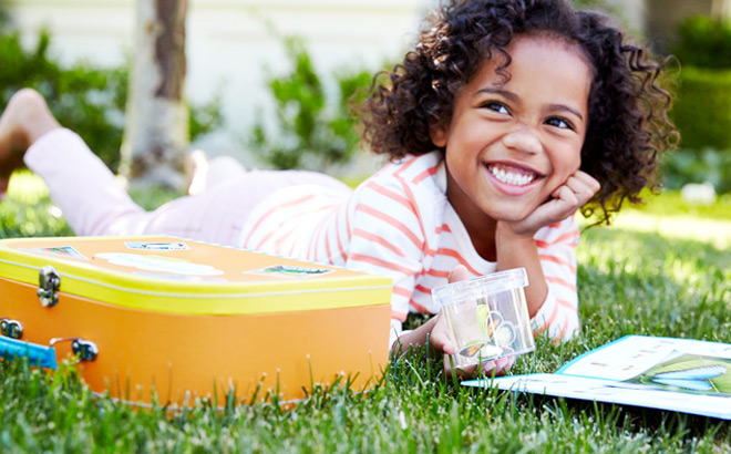 Smiling Child Expoling Butterflies with Little Passports Kit