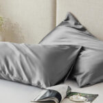 Two Pillows with Satin Pillowcases on a Bed