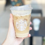 a Hand Holding Starbucks Drink