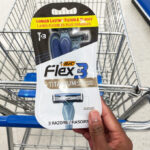 a Person Holding BIC Mens Flex 3 Disposable Razors 3 Pack in front of Walgreens Cart