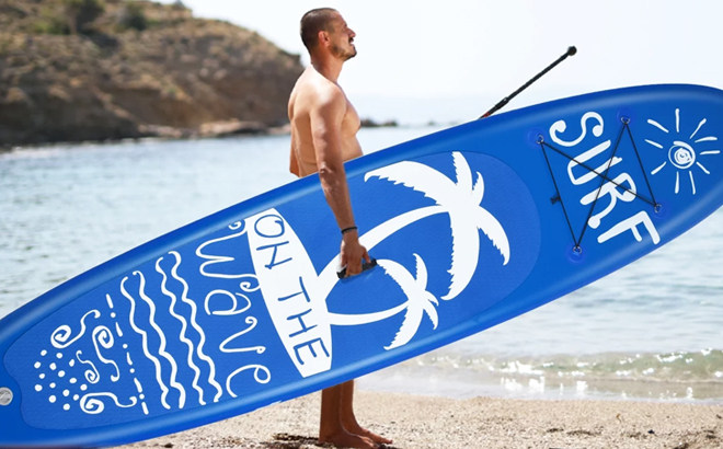 A Man Carrying an Inflatable Stand Up Paddle Board