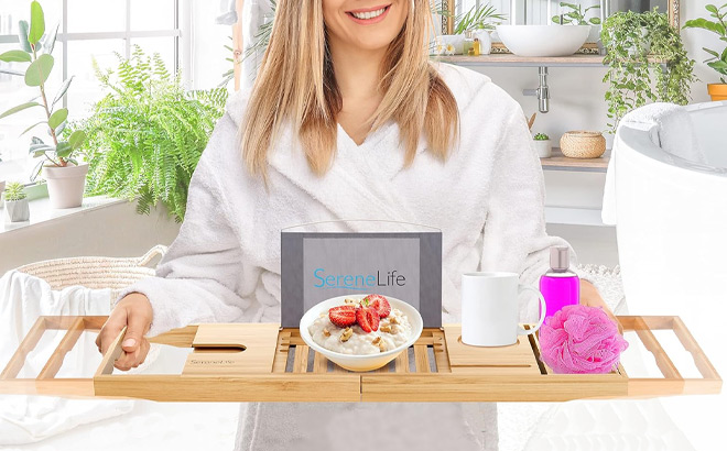 A Person Holding SereneLife Bamboo Bathtub Caddy A Person Holding SereneLife Bamboo Bathtub Caddy