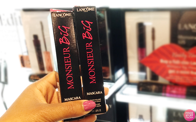 A Person Holding Two Lancome Mr Big Volumizing Mascaras