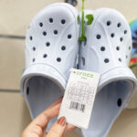 A Person Holding a Tag of Crocs Baya Clogs