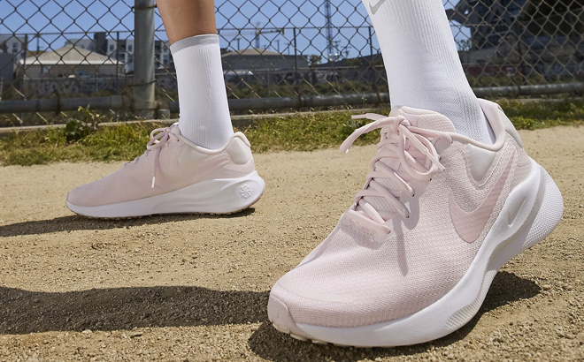 A Person Wearing Nike Revolution 7 Road Running Sneakers A Person Wearing Nike Revolution 7 Road Running Sneakers