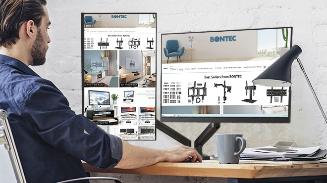 A Person Working Using a Dual Monitor PC
