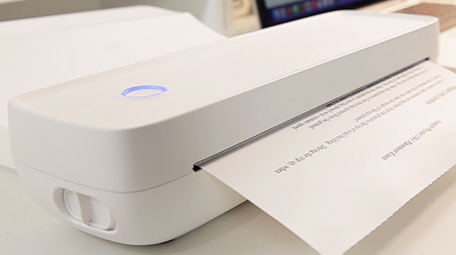 White Portable Wireless Printer on a Desk White Portable Wireless Printer on a Desk