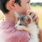 A Boy holding a Cat