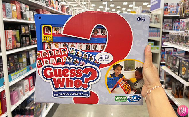 A Hand Holding Guess Who Board Game A Hand Holding Guess Who Board Game
