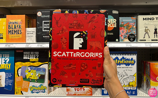 A Hand Holding Scattergories Board Game A Hand Holding Scattergories Board Game