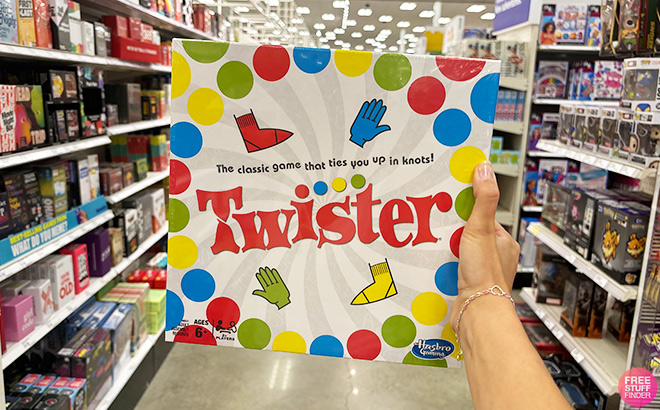 A Hand Hollding Twister Board Game A Hand Hollding Twister Board Game