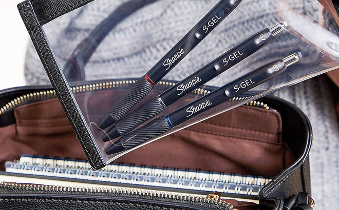 A Person Putting Sharpie S Gel Pens in a Bag A Person Putting Sharpie S Gel Pens in a Bag