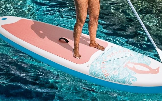 A Person Standing on Tuxedo Sailor Inflatable Stand Up Paddle Board