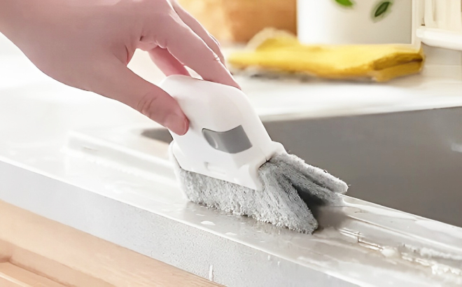 A Person Using a Universal Track Cleaning Brush A Person Using a Universal Track Cleaning Brush