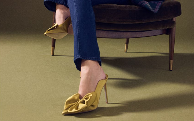A Person Wearing the Sam Edelman Azelea Mule Pumps in Gold A Person Wearing the Sam Edelman Azelea Mule Pumps in Gold