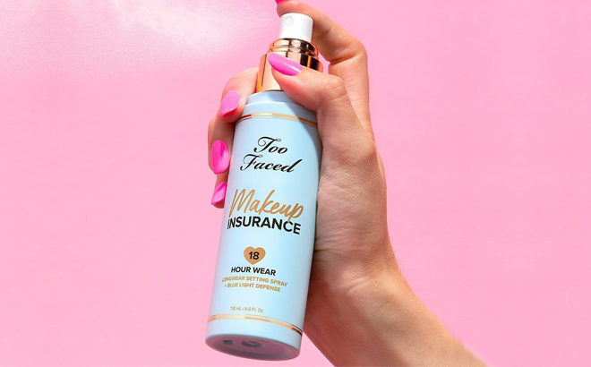 A Woman Holding Too Faced Makeup Insurance Setting Spray