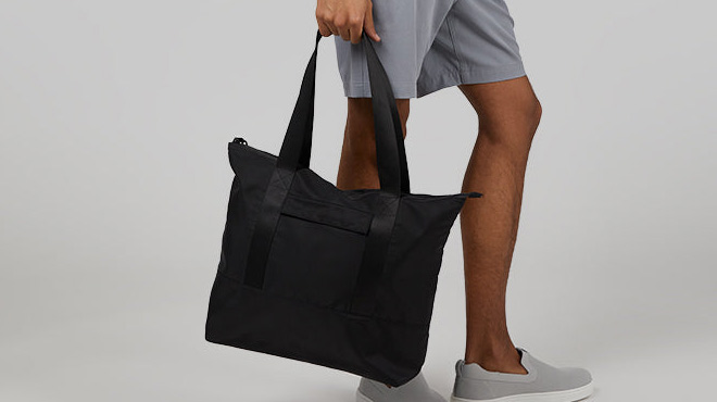 a Person Holding 32 Degrees Travel Tote Bag
