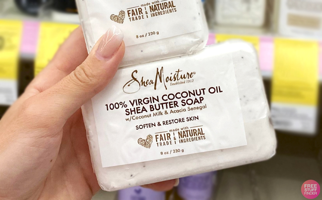 A Hand holding SheaMoisture 100 Virgin Coconut Oil Shea Butter Bar Soap A Hand holding SheaMoisture 100 Virgin Coconut Oil Shea Butter Bar Soap