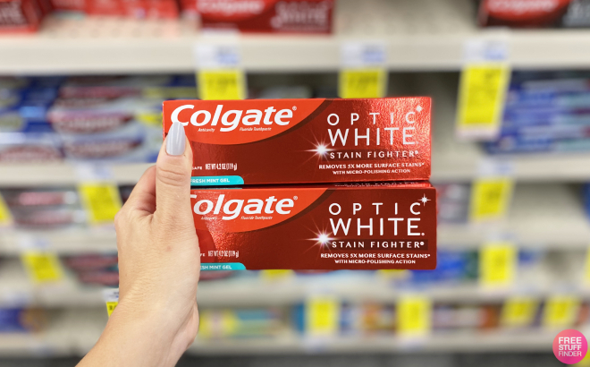 A Person Holding Colgate Optic White Whitening Toothpaste A Person Holding Colgate Optic White Whitening Toothpaste