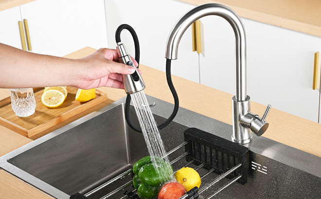 A Person Using a Pull Down Faucet Sprayer A Person Using a Pull Down Faucet Sprayer
