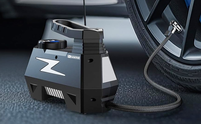 Tire Inflator in Usage on a Car Tire Inflator in Usage on a Car