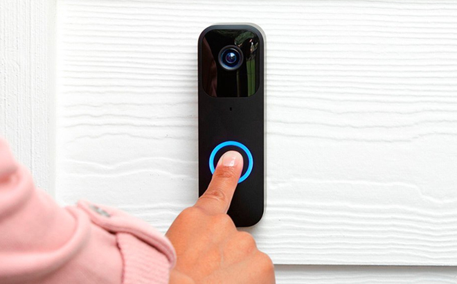 A Finger pressing on a Blink Smart Wifi Video Doorbell