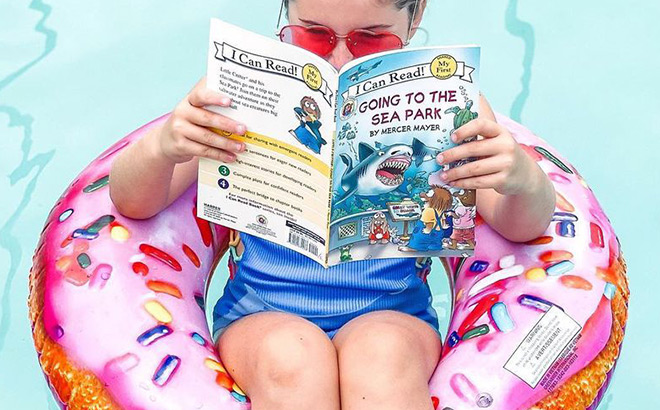 A Kid Reading a Book on a Floatie A Kid Reading a Book on a Floatie