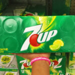 A Person Holding a Box of 7UP Lemon Lime Soda