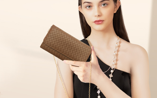 A Person Holding a U U Womens Crossbody Bag in Brown A Person Holding a U U Womens Crossbody Bag in Brown