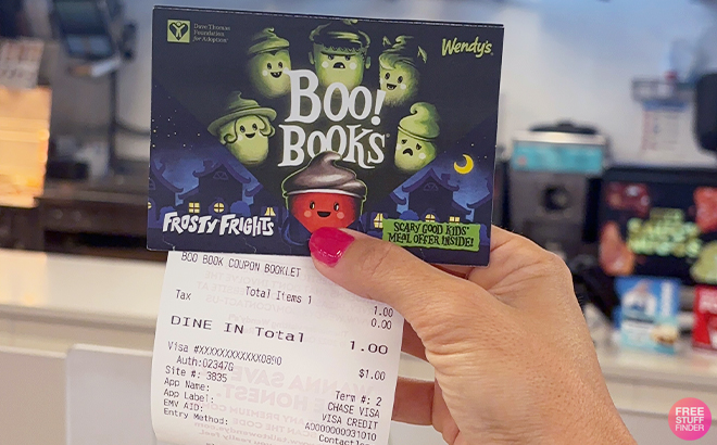A Person Holding the Wendys Halloween Coupon Books Boo Books and a Receipt in Wendys A Person Holding the Wendys Halloween Coupon Books Boo Books and a Receipt in Wendys