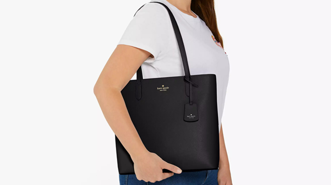 A Person wearing Kate Spade Brynn Tote Bag in Black Color A Person wearing Kate Spade Brynn Tote Bag in Black Color