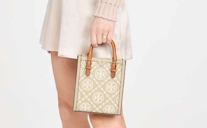 A Woman Holding Tory Burch Mini T Monogram Contrast Embossed Tote A Woman Holding Tory Burch Mini T Monogram Contrast Embossed Tote