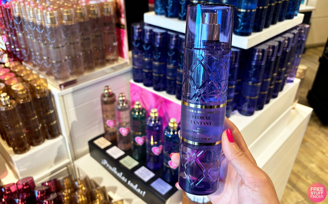 A person holding a bottle of Bath Body Works Floral Fantasy Fragrance Mist A person holding a bottle of Bath Body Works Floral Fantasy Fragrance Mist