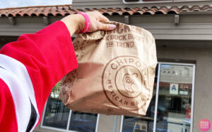 A Hand holding a Chipotle Bag