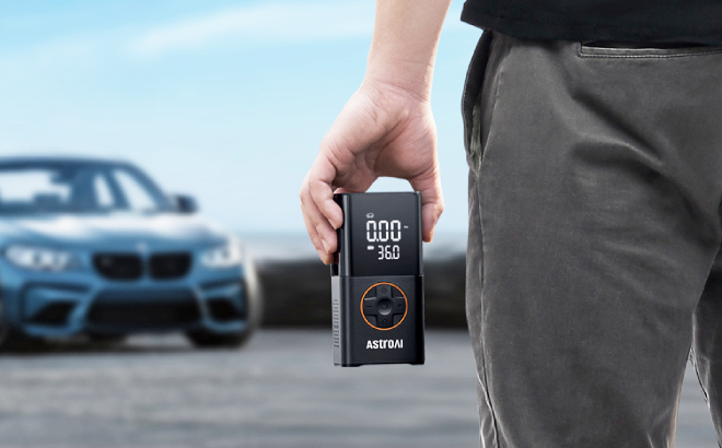 A Person Holding an AstroAI L7 Portable Tire Inflator A Person Holding an AstroAI L7 Portable Tire Inflator