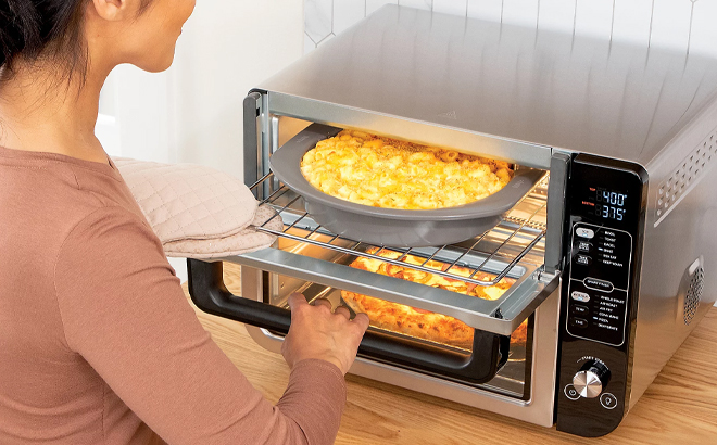 A Woman Cooking with the Ninja 12 in 1 Rapid Cook Convection Double Oven A Woman Cooking with the Ninja 12 in 1 Rapid Cook Convection Double Oven